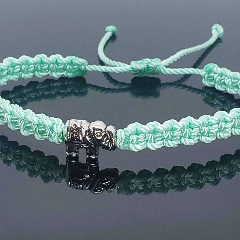 hand-made mint string bracelet with an elephant